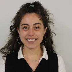 Woman with blue eyes and brown curly hair