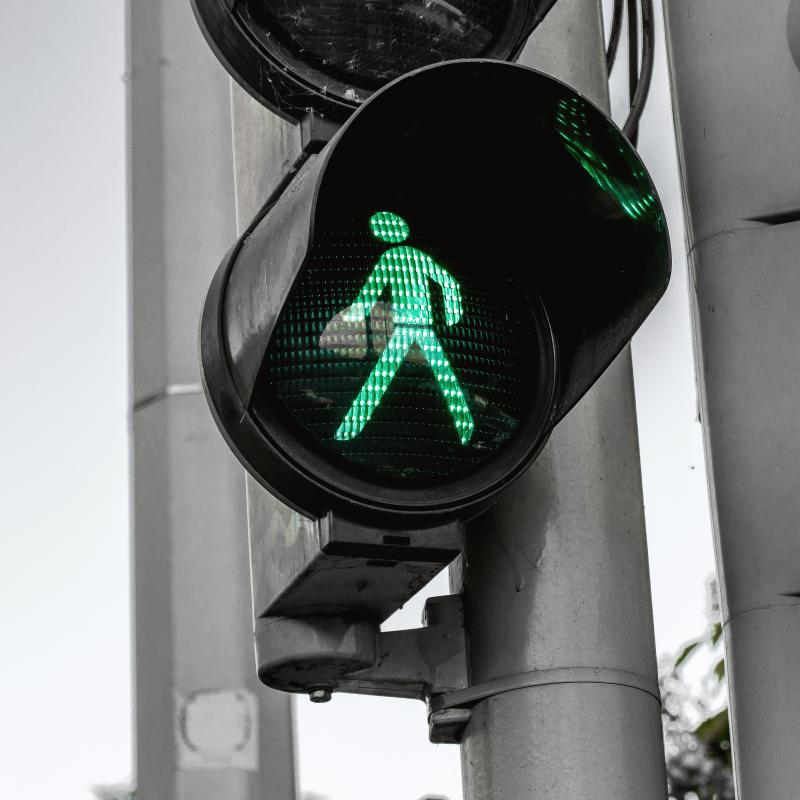 Green man pedestrian crossing sign