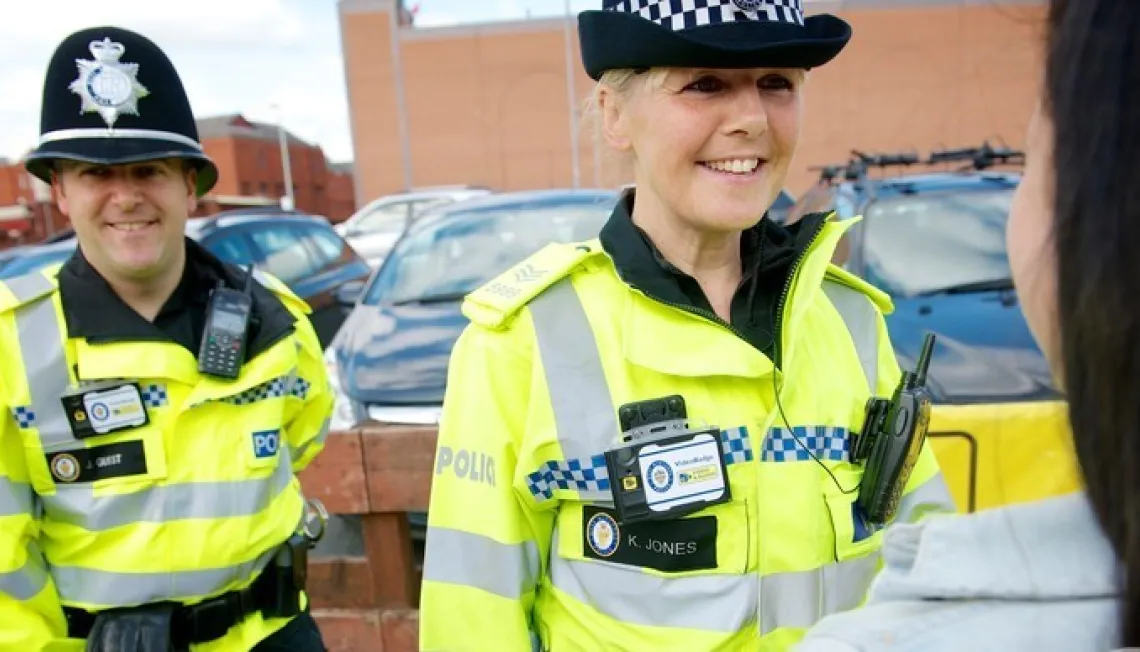 2 police officers helping a woman