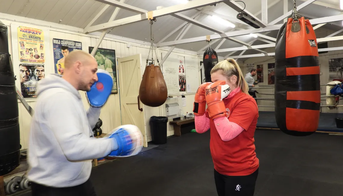 A man and a woman boxing