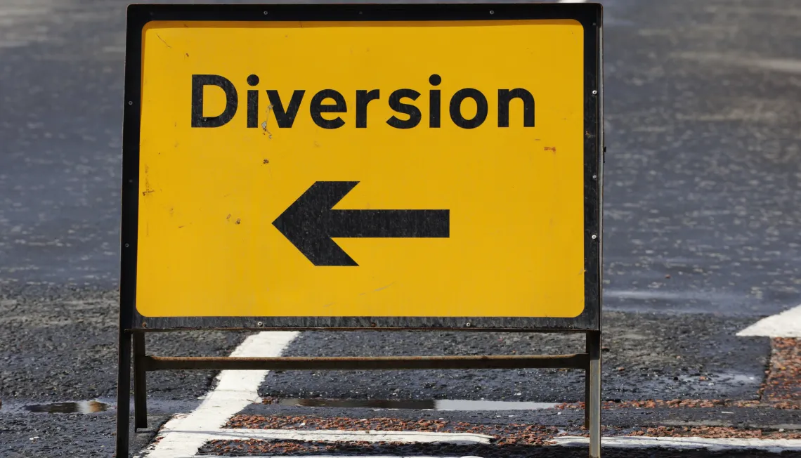 Photograph of a 'Diversion' road sign with an arrow 